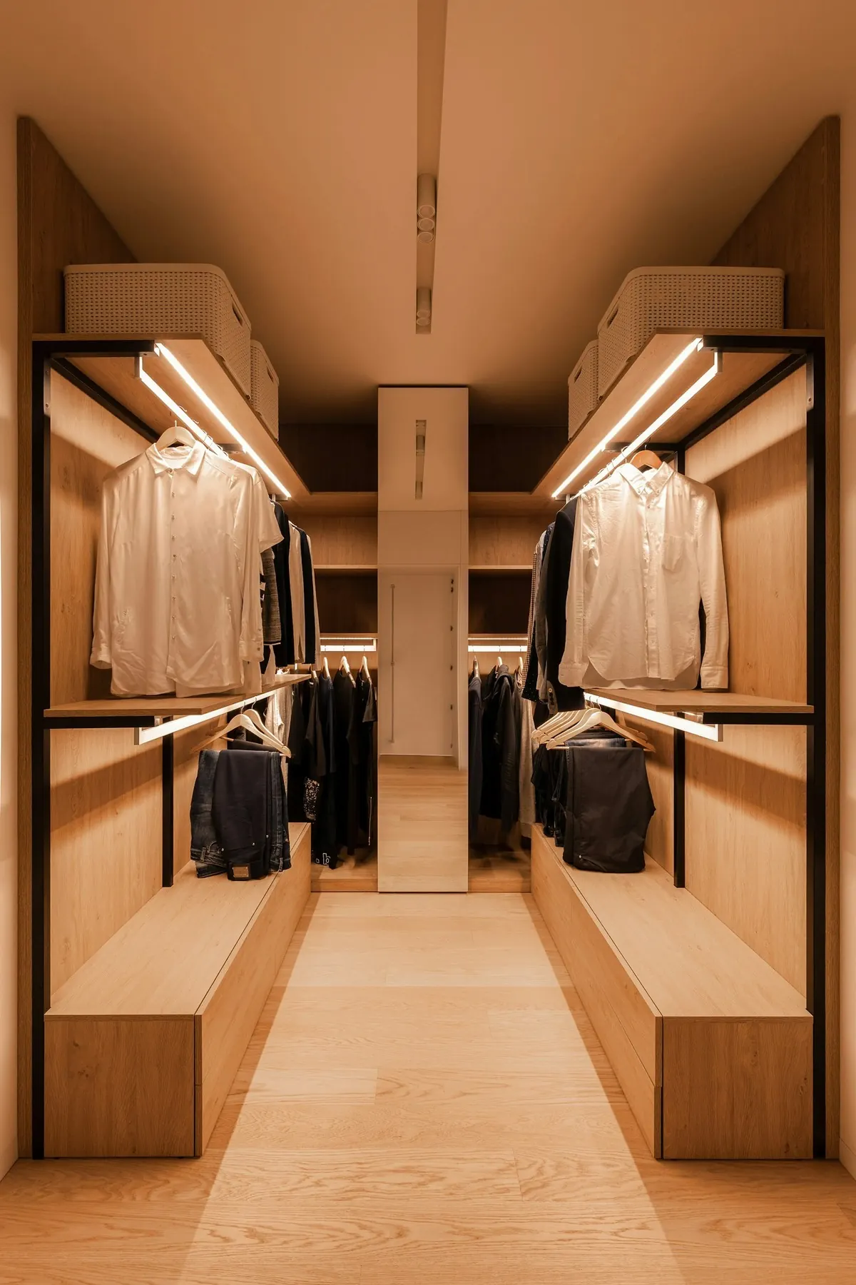 Walk-in closet with oak shelving and warm lighting