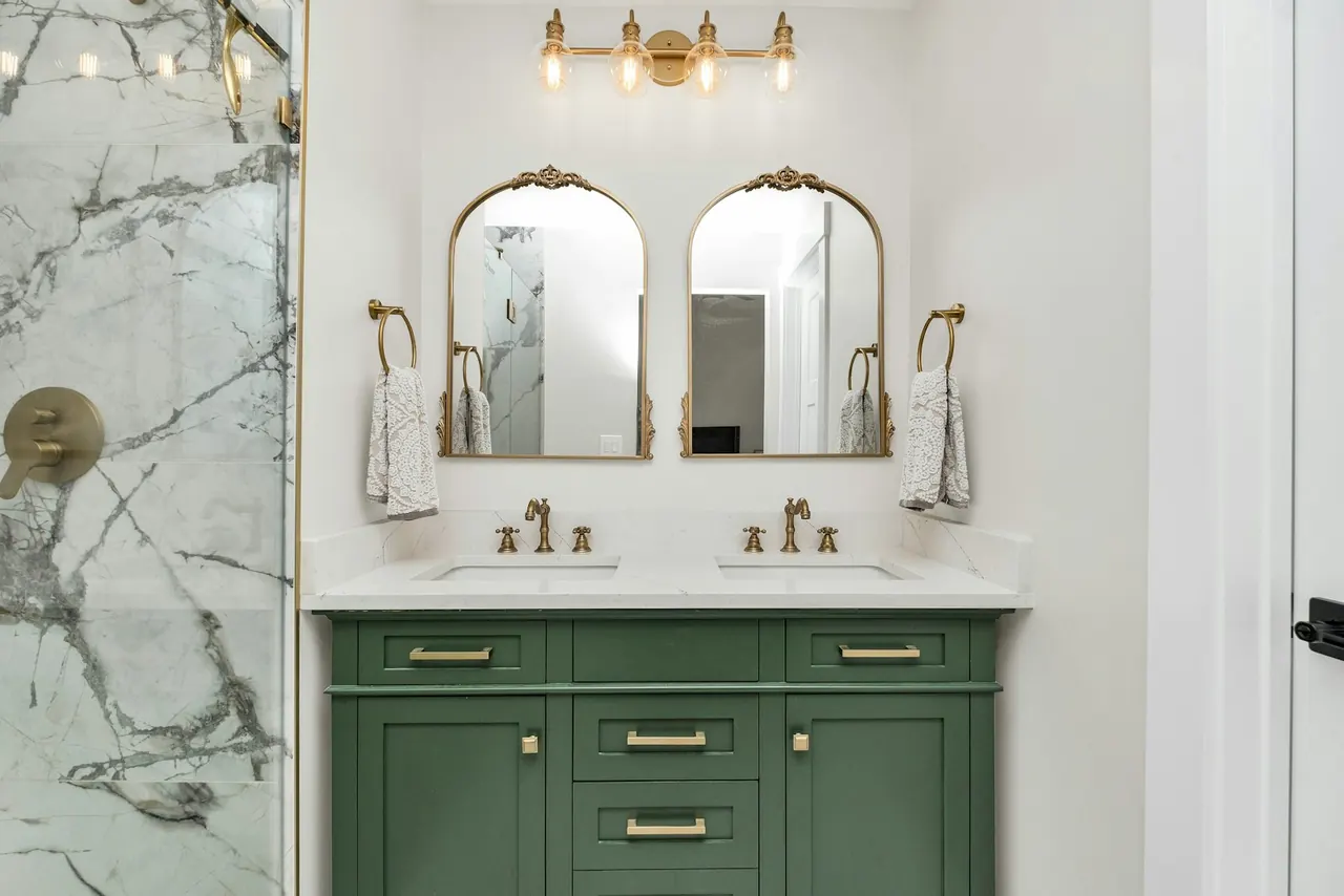 Green shaker double vanity with brass hardware
