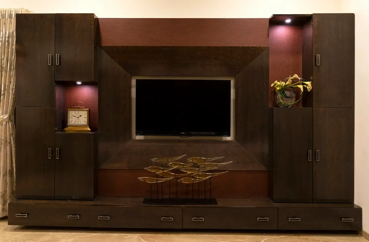 Dark wood entertainment center with lit display niches