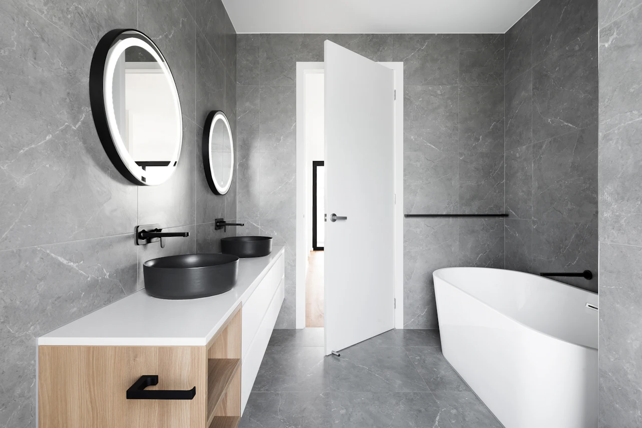 Floating wood vanity with round mirrors