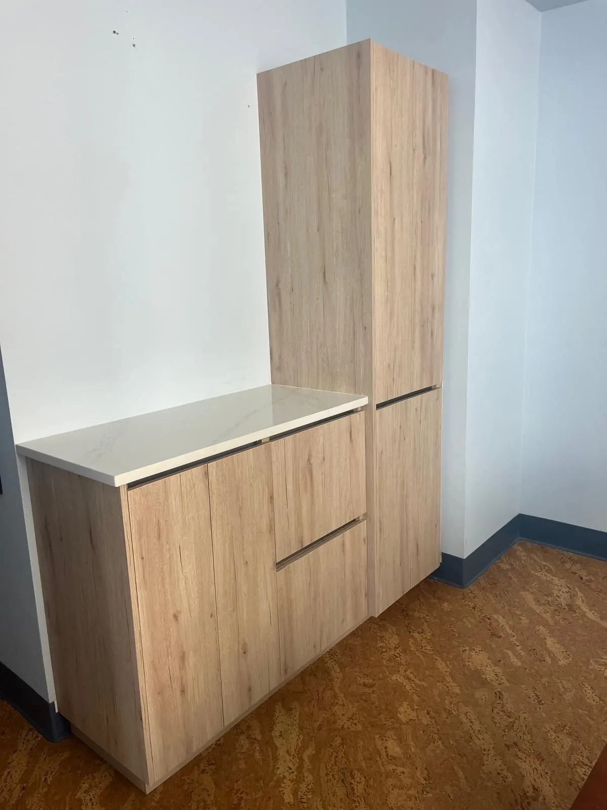 Oak pantry tower and buffet cabinet with a stone top
